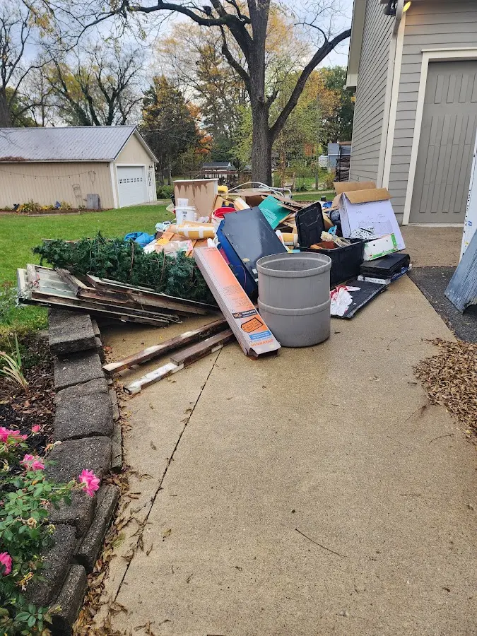 Dumpster being loaded with debris for Estate Cleanout Dumpster Rental in Port Sheldon
